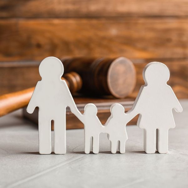 Cutout of a Mom, Dad, and two kids in front of a gavel. 