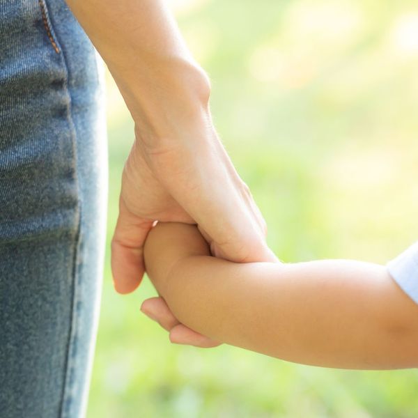 parent and child holding hand