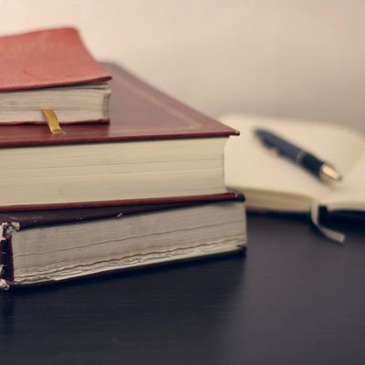 image of stacked books and journal