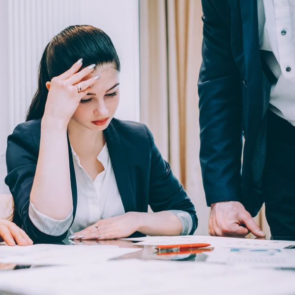 woman looking stressed while examining papers
