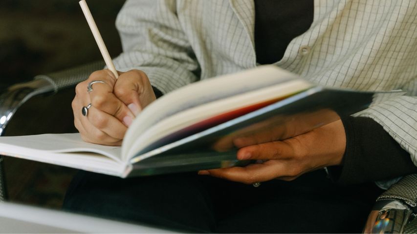 woman writing in notebook