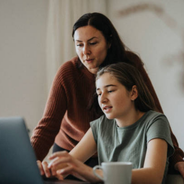 mom and daughter looking at a laptop. 