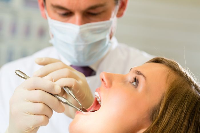 dentist looking at woman mouth