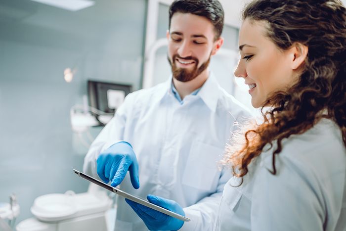 doctor and hygienist looking at files