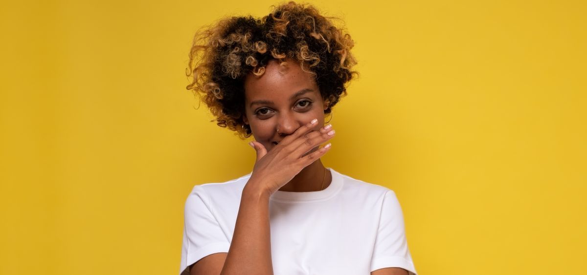 hiding-smile-AdobeStock_384444499.jpg