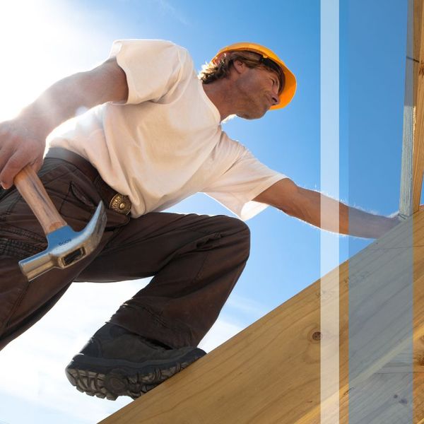 Arizona roofer climbing up a ladder with a hammer