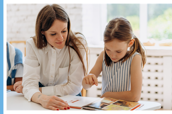 teacher helping child to read