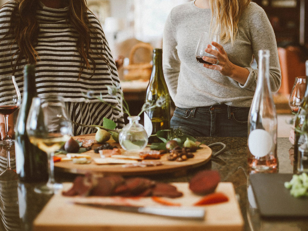 Two women standing around a table set for a private party.