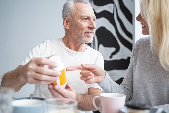 Older couple taking supplements