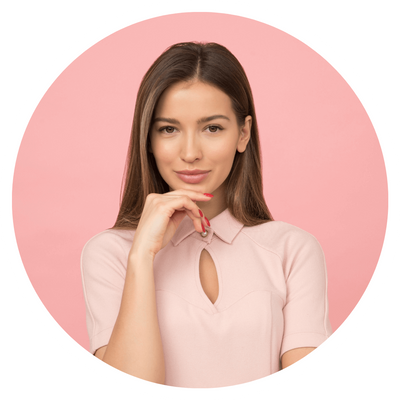 Woman posing against a pink background, thoughtful expression