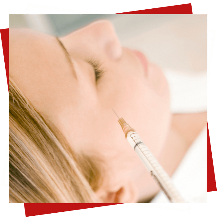 Side view of woman receiving facial injection, eyes closed