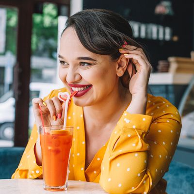 Woman smiling drinking healthy juice