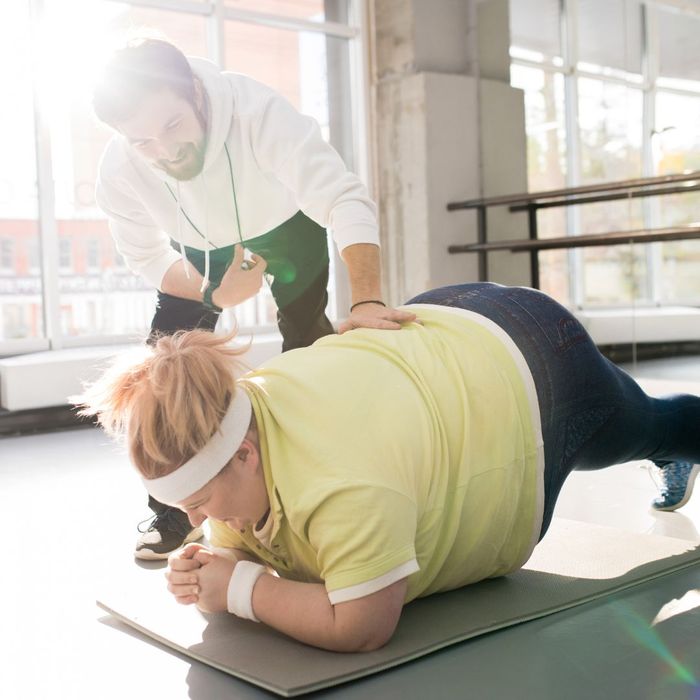 woman being coached through her workout