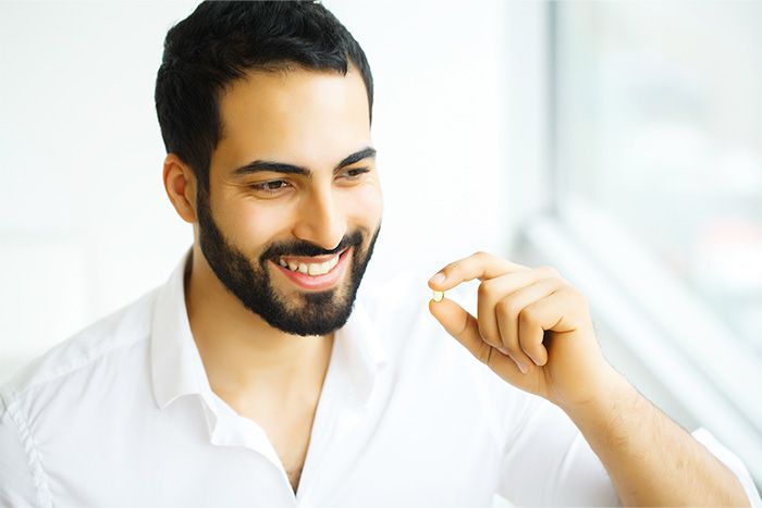 Man with a pill in hand