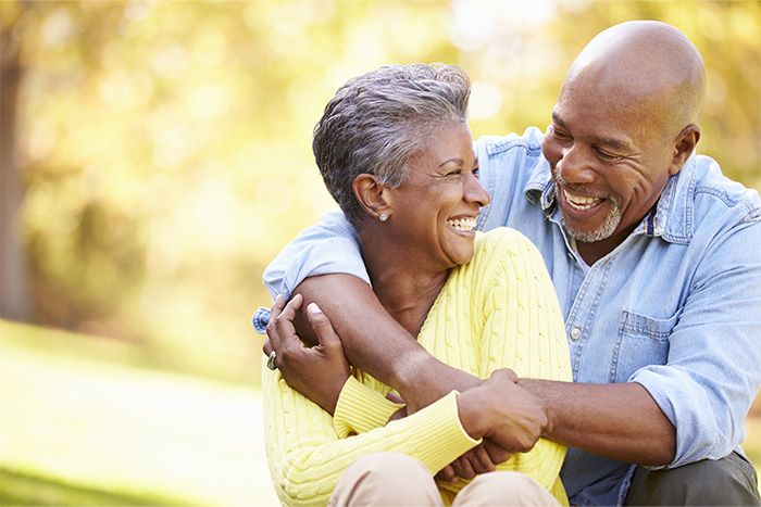 A mature couple outdoors and happy