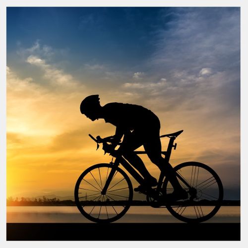 A cyclist riding at sunset 