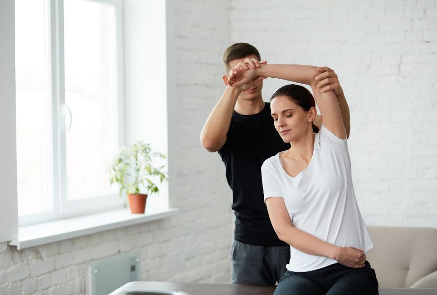 woman at physical therapy stretching her arm