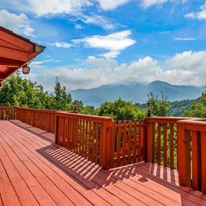 Red stained deck with a view of the Smoky Mountains outside of a vacation getaway cabin