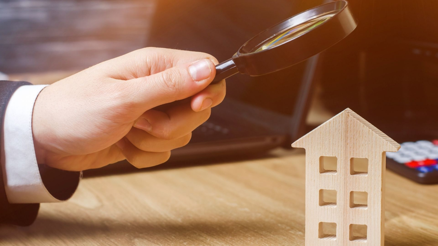 magnifying glass on a wooden house