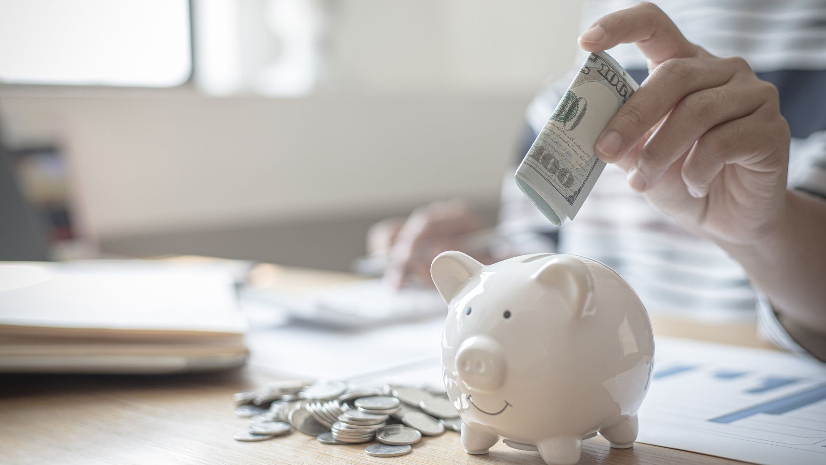 putting money into a piggy bank