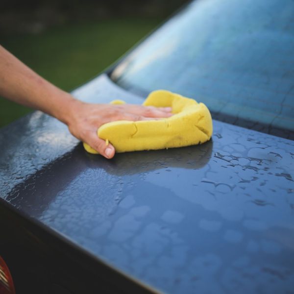 wiping car with sponge