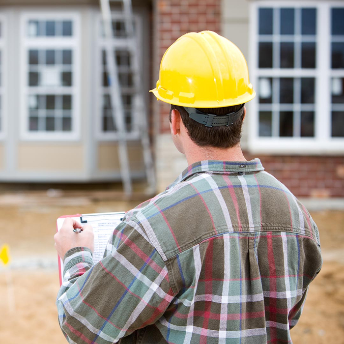 Man performing a home inspection on a new house