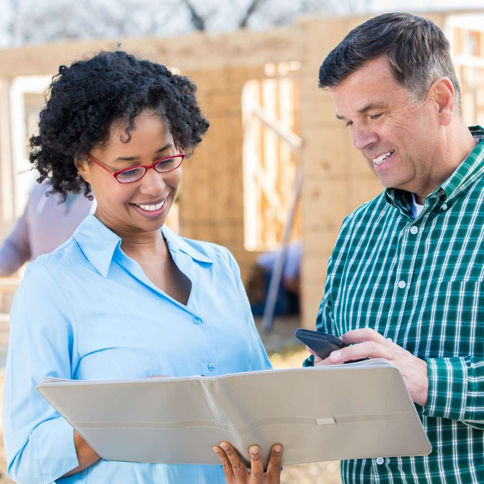 man and woman looking over plan together