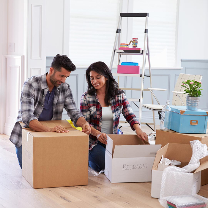 Man and woman unpacking labeled boxes