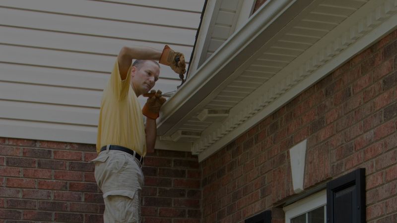 homeowner cleaning gutters