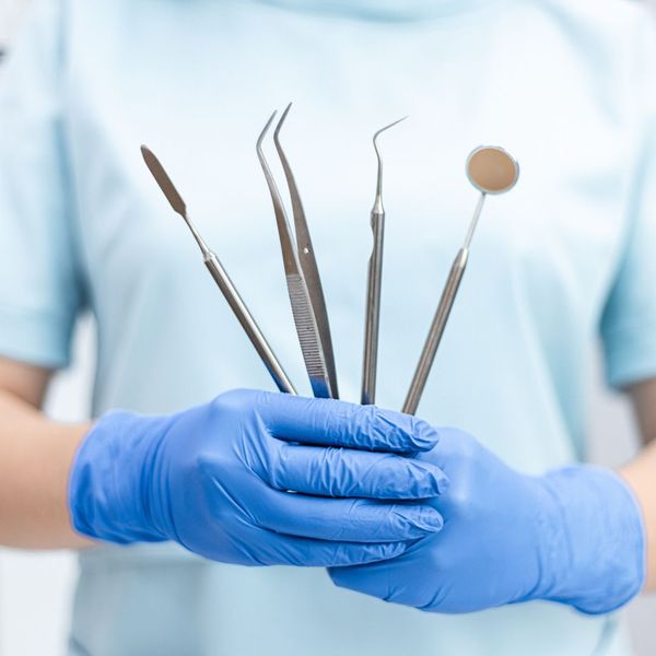 dentist holding dental instruments