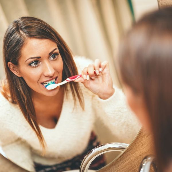 woman brushing her teeth