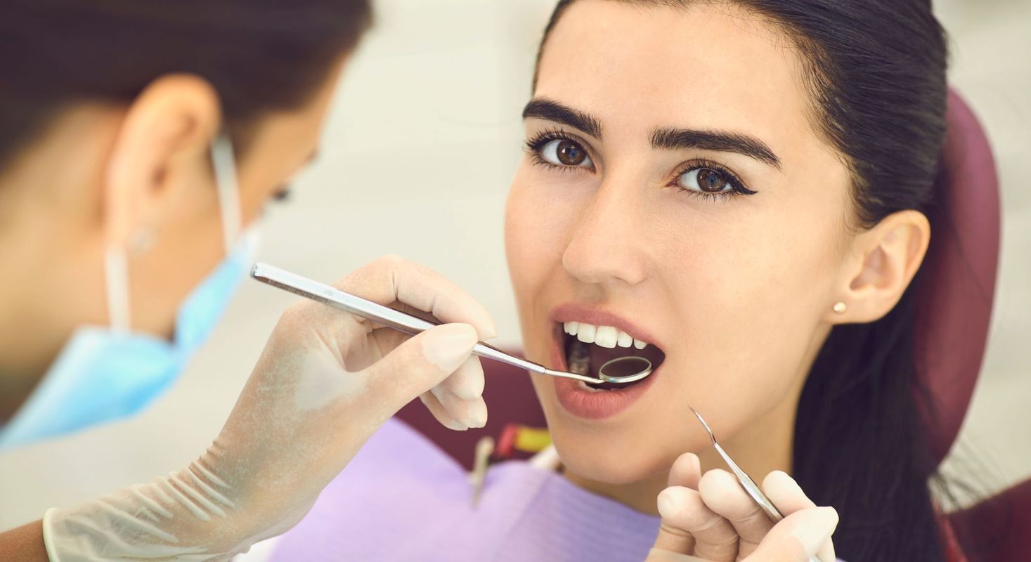 dentist checking a patient's teeth