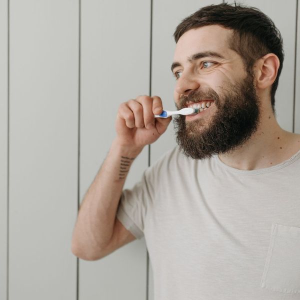 man brushing teeth