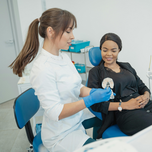 A dentist explaining something to a patient