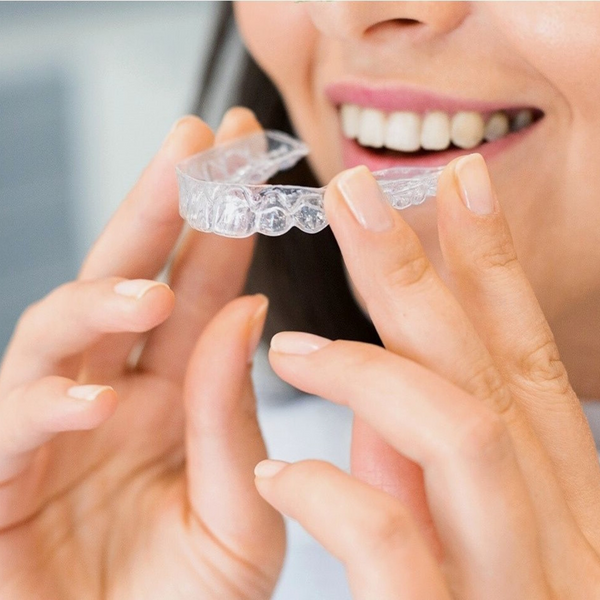 Invisalign being placed into a mouth