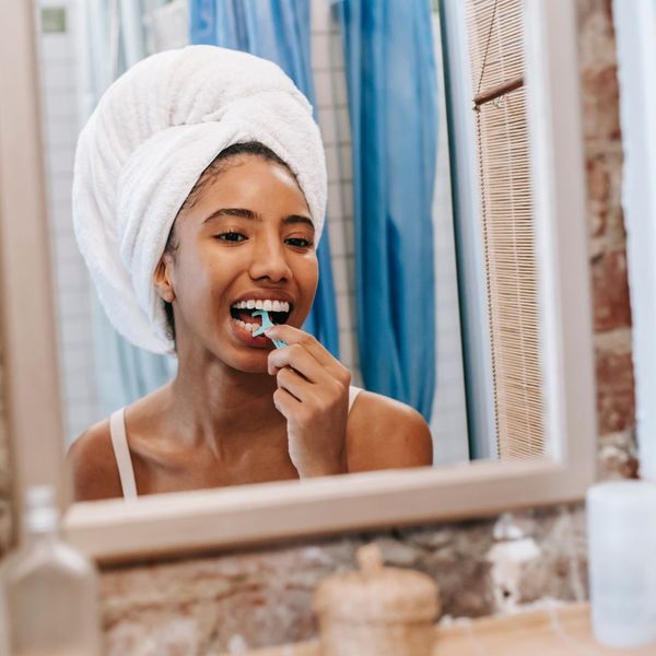 Woman flossing her teeth