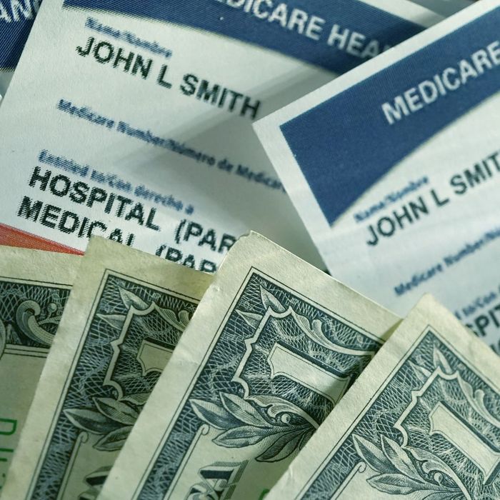 Image showing Medicare cards next to money