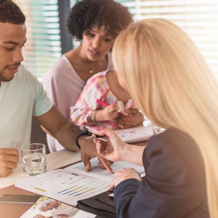 Image of an insurance agent helping a family