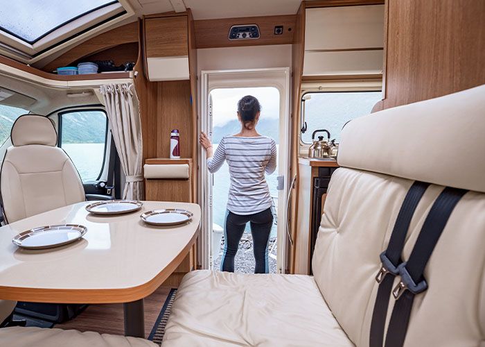 RV interior with a woman looking out from the door