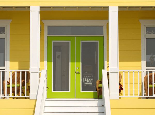 glass front doors on a yellow house