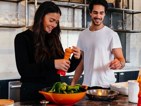 woman and man cooking in kitchen 