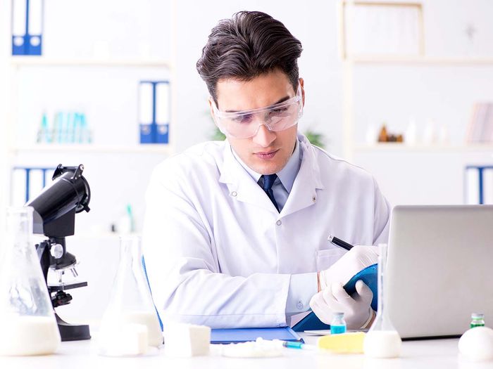 man in lab testing cheese