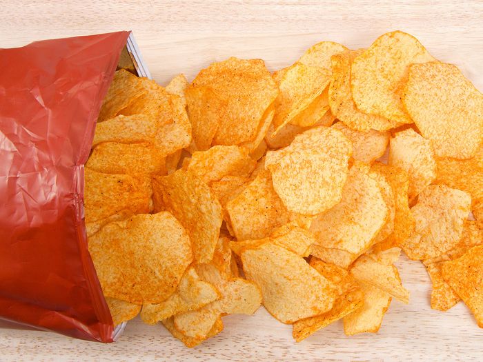Bag of potato chips open on table
