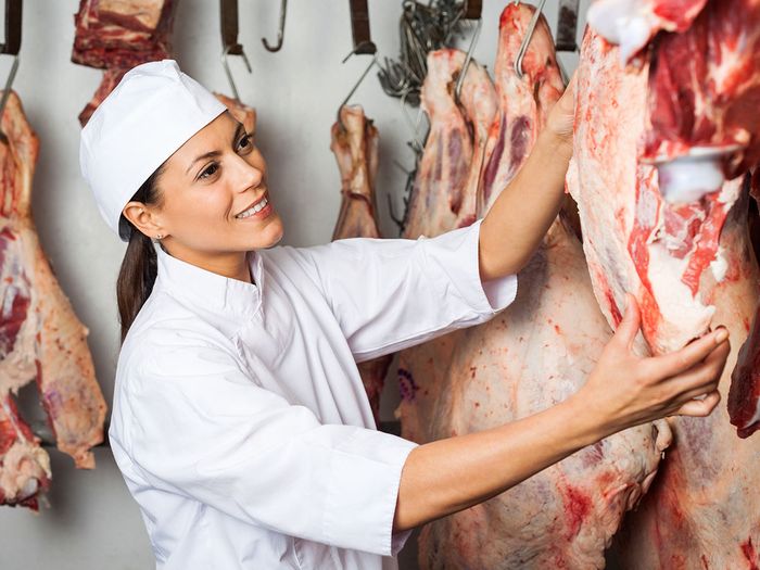 Image of a woman testing meat