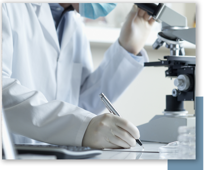 scientist looking through microscope