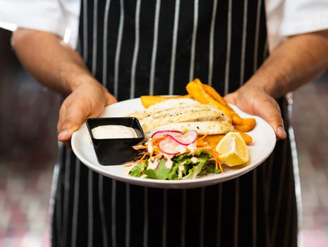 someone holding a dish of food