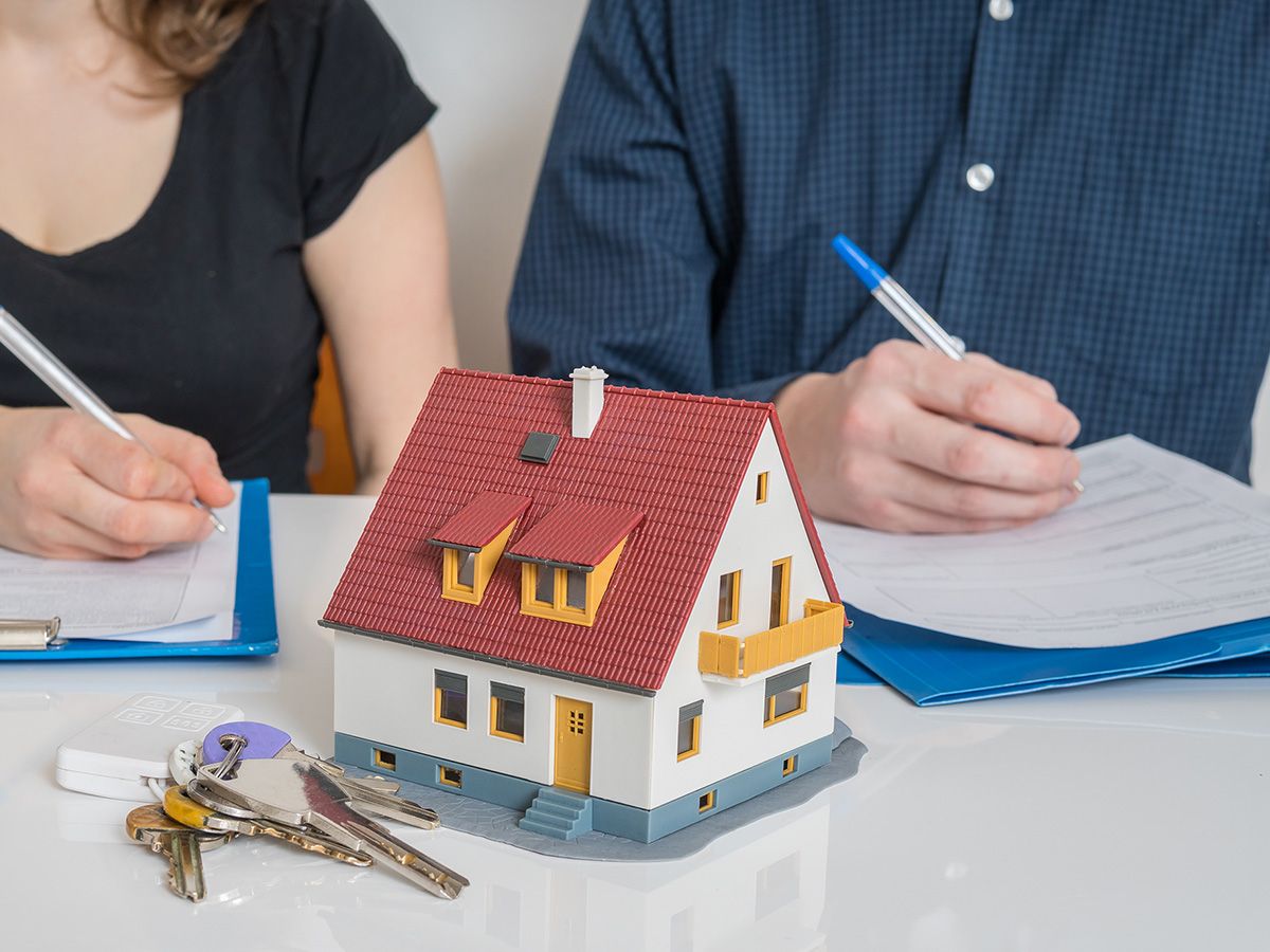 photo of couple filling out paperwork regarding property