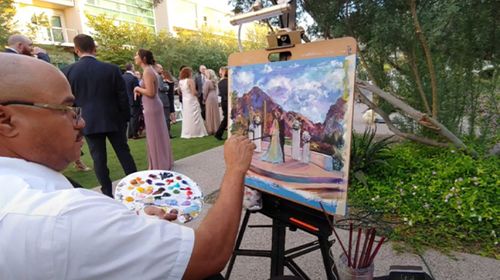 Robert in the process of painting a wedding