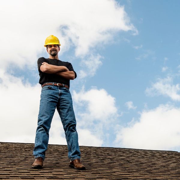 Man smiles on top of roof