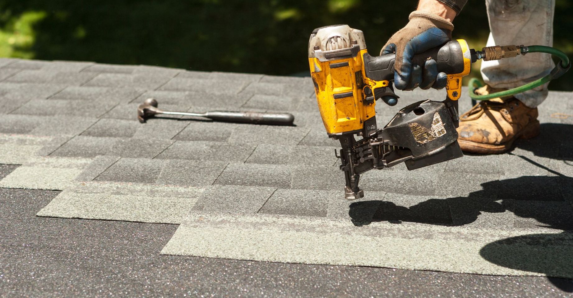 Roof contractor nails in shingles